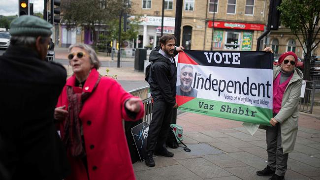 Campaigners hold a flag promoting Vaz Shabir, a pro-Palestine independent candidate in the recent British election.