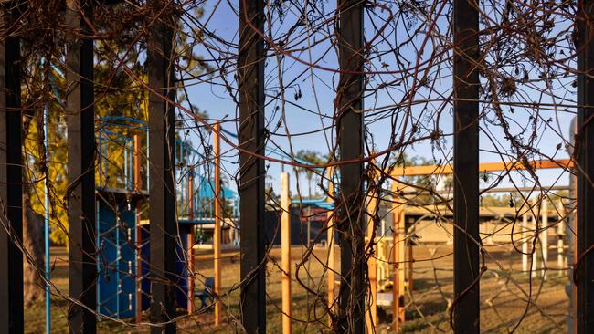 A rusting playground sits empty behind an imposing fence at Angurugu. Picture: Rebecca Parker