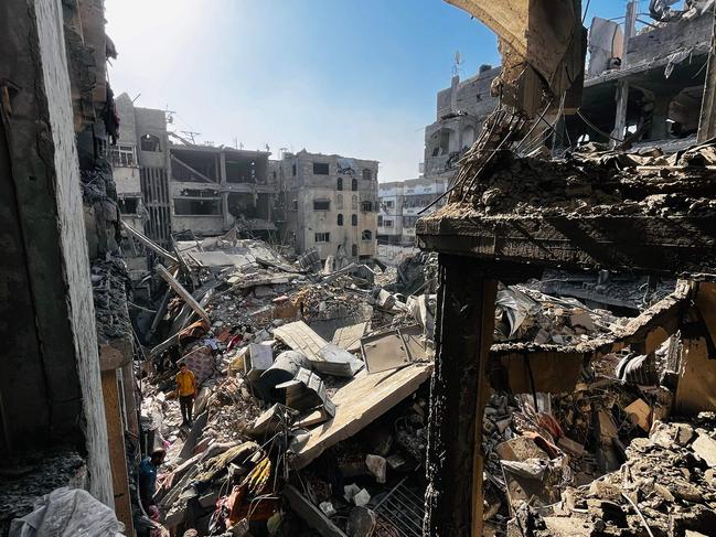 Palestinians search through the rubble of a building after an Israeli strike in Beit Lahia, in the northern Gaza Strip. Picture: AFP