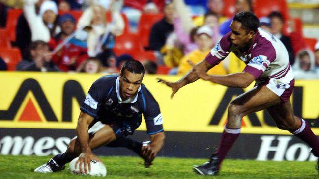 Amos Roberts scores four of his 28 points during Penrith’s 72-12 win over Manly in 2004. Picture: Jenny Evans