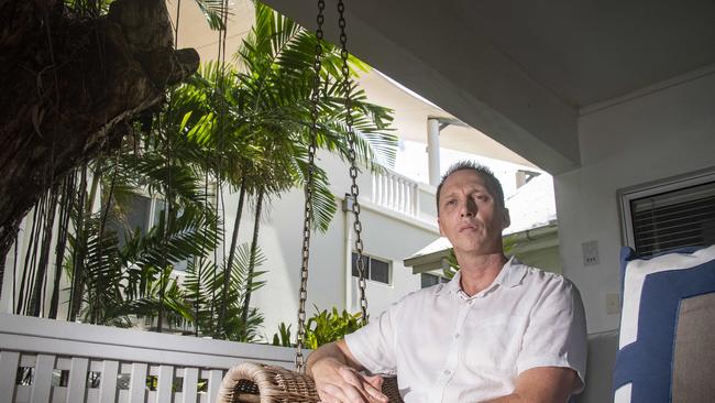 Reef House manager Wayne Harris sits at one of the units that will reportedly be unusable if the rooftop bar, whose balcony is visible, is allowed to go ahead. Picture: Brian Cassey