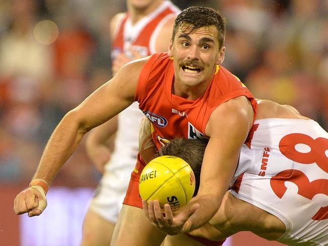 Andrew Boston of the Suns gets a handball away during the round 10 AFL match between the Gold Coast Suns and the Sydney Swans at Metricon Stadium on June 6, 2015 in Gold Coast, Australia. (Photo by Bradley Kanaris/AFL Media/Getty Images)