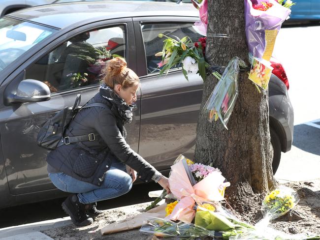 Suzanne Wright, who witnessed the scene on Sunday, lays flowers at a memorial where a 27-year-old Dutch female cyclist was killed. Picture: David Crosling