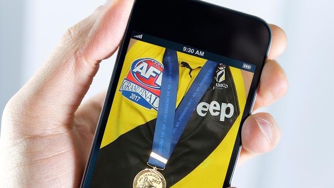 Police have closed their investigation of a Richmond player who circulated a photo of a young woman wearing his AFL premiership medal. Generic picture