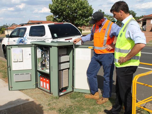 Hume Federal Liberal MP Angus Taylor (right) inspects a node in Holdsworth Drive, in Narellan Vale, with NBN crews to view the progress.