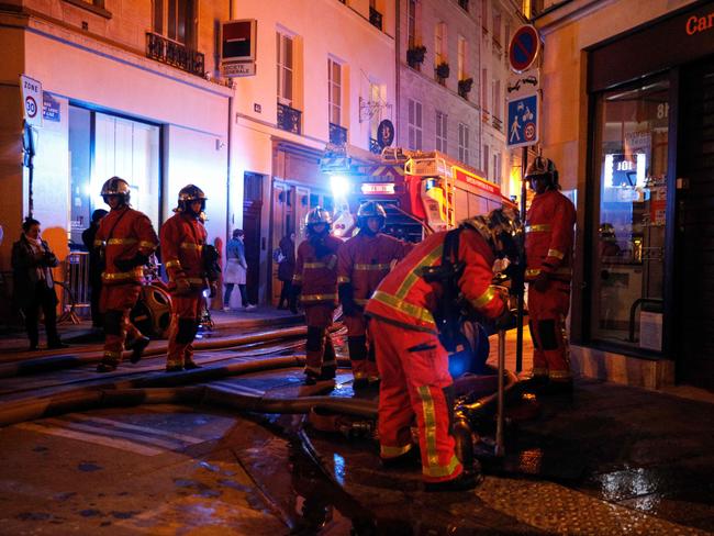 French fire fighters open water supply points as others douse a fire that engulfed the roof of the Notre-Dame de Paris Cathedral on April 15, 2019 in Paris. Picture: GEOFFROY VAN DER HASSELT / AFP