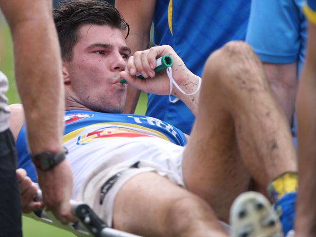 Jaeger O'Meara is taken off on a stretcher after injuring his knee during a pre-season game last year. Picture: Jono Searle