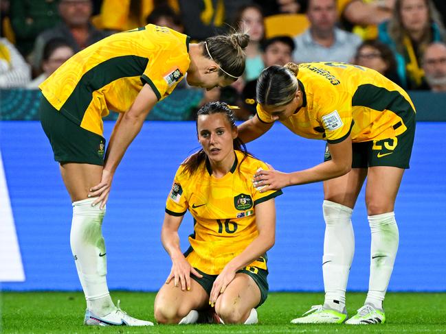 Hayley Raso of Australia is comforted by Ellie Carpenter of Australia during the FIFA Women's World Cup 2023 soccer match between Australia and Nigeria at Brisbane Stadium in Brisbane, Thursday, July 27, 2023. (AAP Image/Darren England) NO ARCHIVING, EDITORIAL USE ONLY