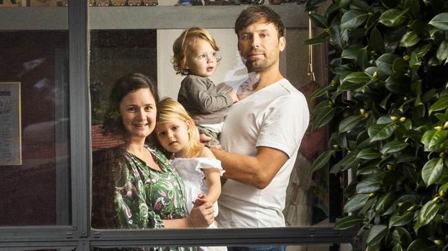 Kristie Young at her home in Langwarrin, Melbourne, with Airlie, 3, Bowen, 18 months, and partner Christopher Morrison. Picture: Aaron Francis