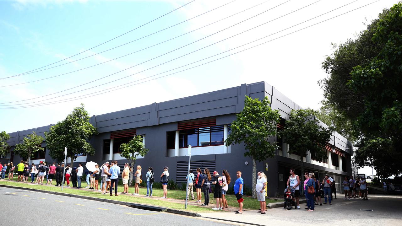 Lines of people wait at Southport Centrelink. Picture: Adam Head.