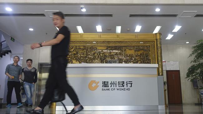 A man walks through the lobby of the Bank of Wenzhou. Picture: Erika Kinetz