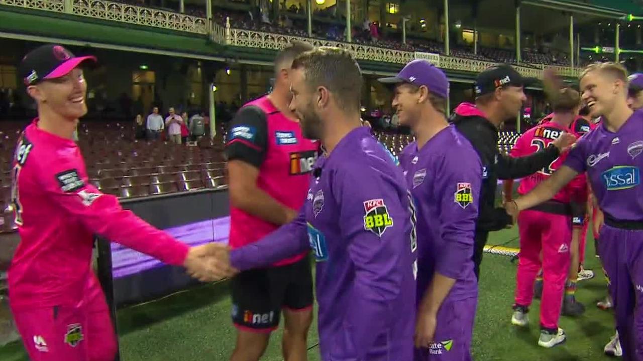 The Sixers and the Hurricanes shake hands after the game at the SCG is called off.