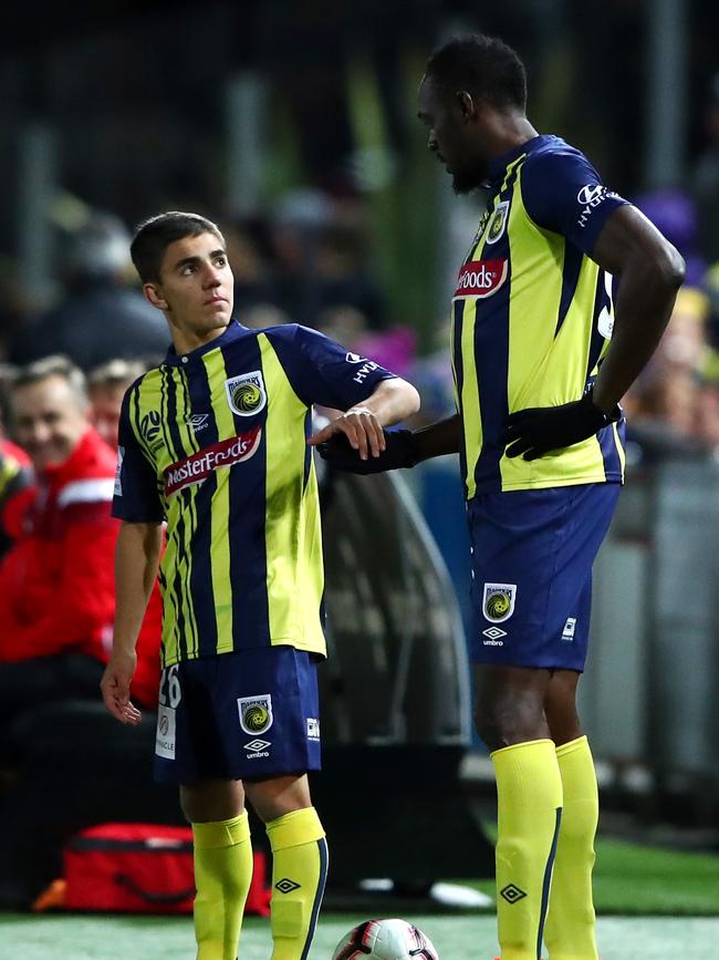 Bolt prepares to run on with team mate Josh Nisbet.
