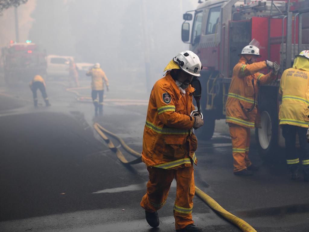 NSW Rural Fire Service work to protect property in Woodford NSW. Picture: AAP Image/Dan Himbrechts