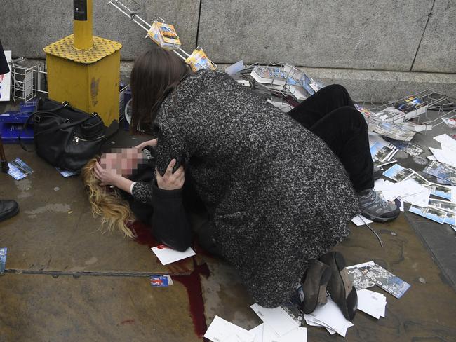 A woman lies injured after an incident on Westminster Bridge in London, March 22, 2017. REUTERS/Toby Melville