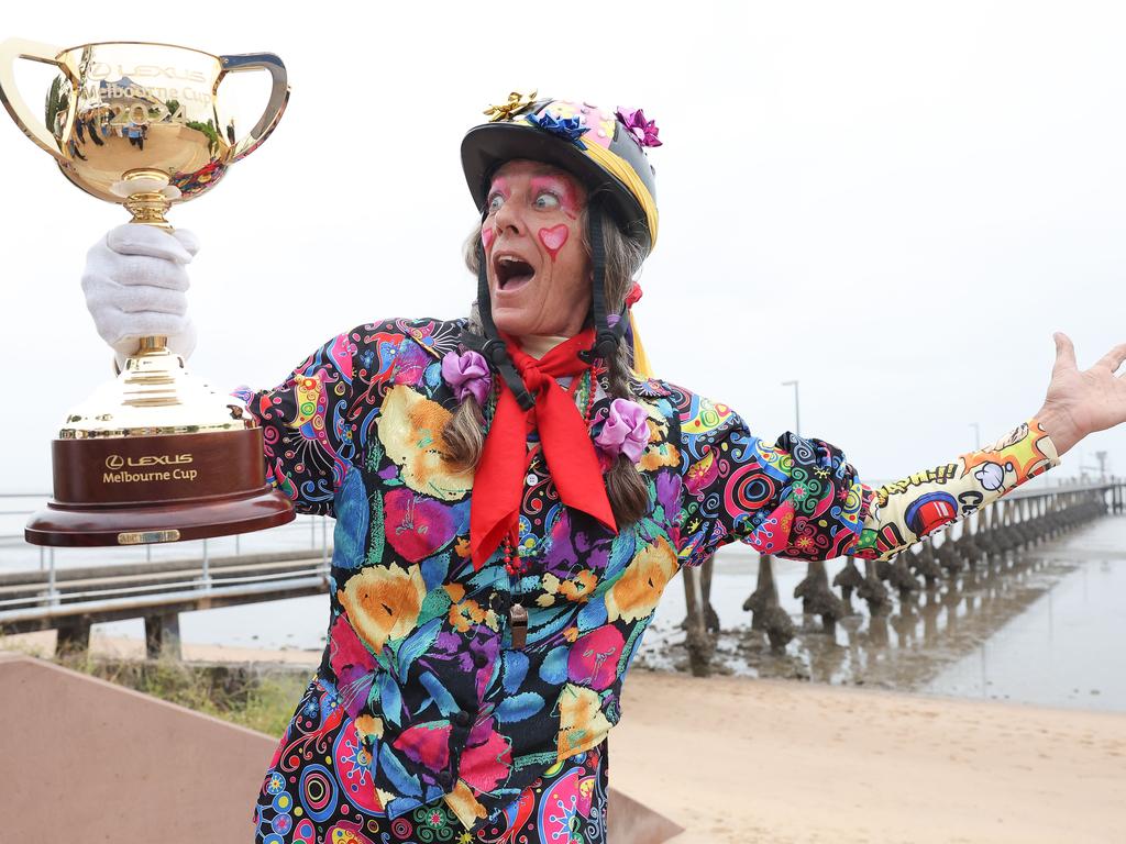 Lara the clown holding the Lexus Melbourne Cup trophy in Cardwell, Queensland. Picture: Lucas Dawson