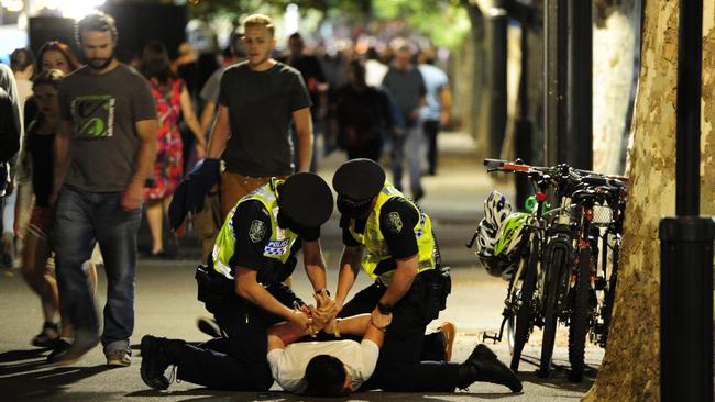 Police arrest a man on King William St, near Elder Park — the CBD’s noisiest spot. Picture: Mark Brake