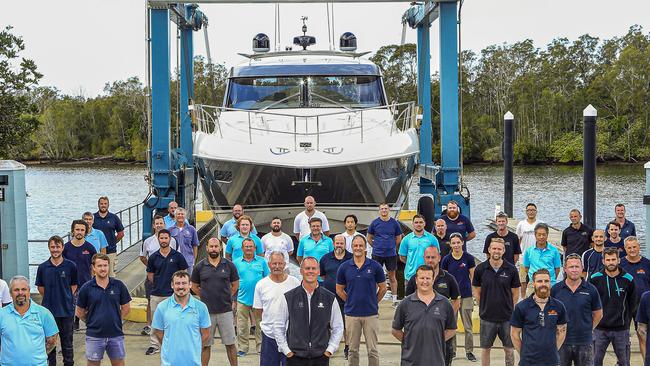 Members of the team that have constructed the 100th 5400 Platinum Edition Sport Yacht stand proud with Riviera owner Rodney Longhurst at the 16.8-hectare world class facility at Coomera.