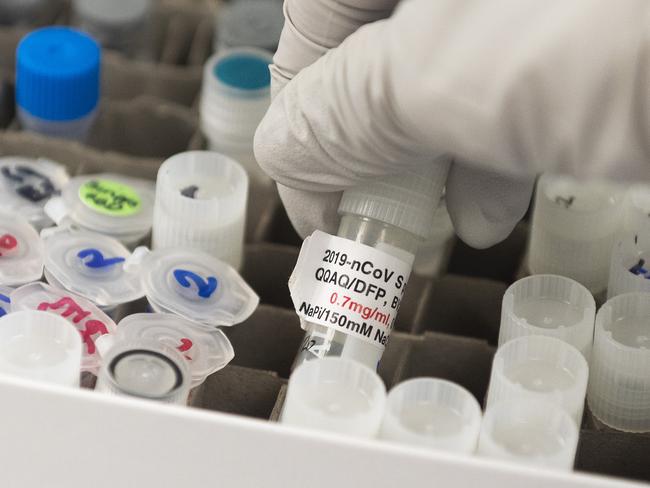 (FILES) In this file photo Dr. Nita Patel, Director of Antibody discovery and Vaccine development, lifts a vial with a potential coronavirus, Covid-19, vaccine at Novavax labs in Gaithersburg, Maryland, one of the labs developing a vaccine for the coronavirus, Covid-19. - The US Food and Drug Administration made public its guidance for issuing emergency approval for a Covid-19 vaccine on October 6, 2020, making it clear it wants to see follow-up two months after trial volunteers have their second dose. (Photo by ANDREW CABALLERO-REYNOLDS / AFP)