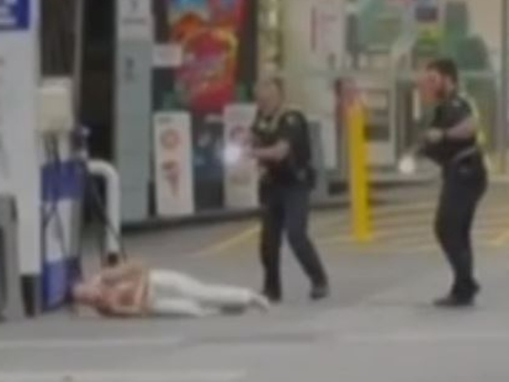 Police taser a woman accused of lighting a fire at a Windsor petrol station. Picture: 7News