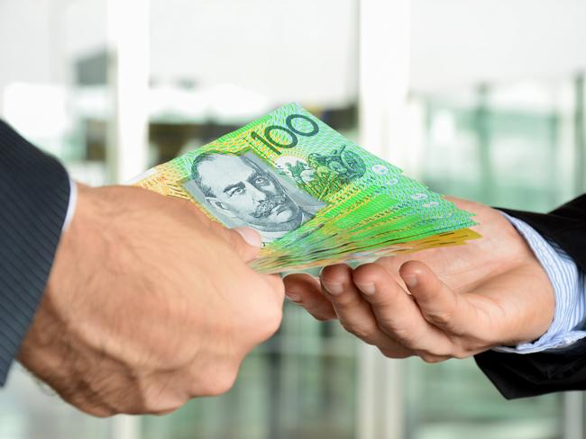 Hands of businessmen passing money, Australia dollar bills