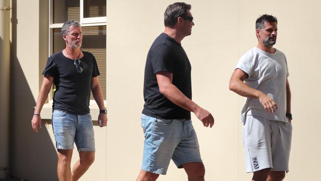 Adelaide United's coach Marco Kurz and assistants Frank Juric and Filip Tapalovic leave the meeting with players at Hindmarsh. Picture MATT TURNER