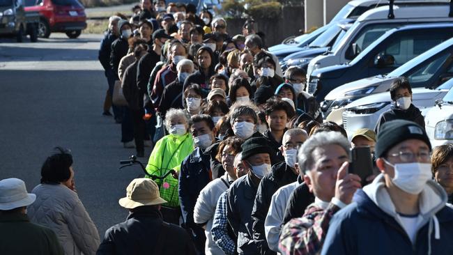 People queue around the Shika Town hall as they wait to receive water at a distribution point in Shika, Ishikawa prefecture. Picture: Kazuhiro NOGI / AFP