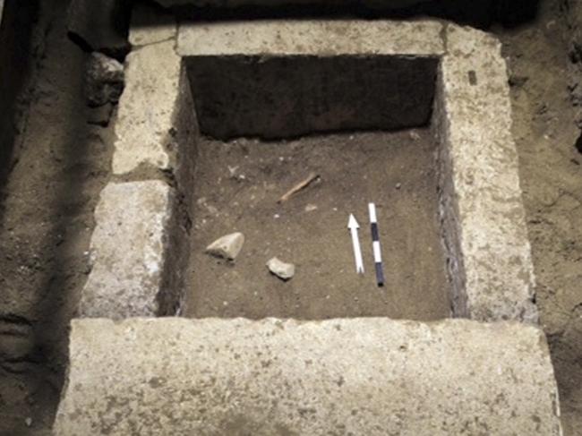 This picture provided by Greece's Culture Ministry on Wednesday, Nov. 12, 2014, shows the top of a stone-lined cistern found in a large 4th century B.C. tomb under excavation at Amphipolis in northern Greece. Bones from a skeleton found in the tomb's innermost chamber could help solve the riddle of who was buried in opulent splendor there. A Culture Ministry statement on Wednesday, Nov. 12, 2014, said the skeleton was strewn in and around the cistern under the floor of the cavernous, vaulted structure that is 8 metres (26 feet) tall. (AP Photo/Greek Culture Ministry)