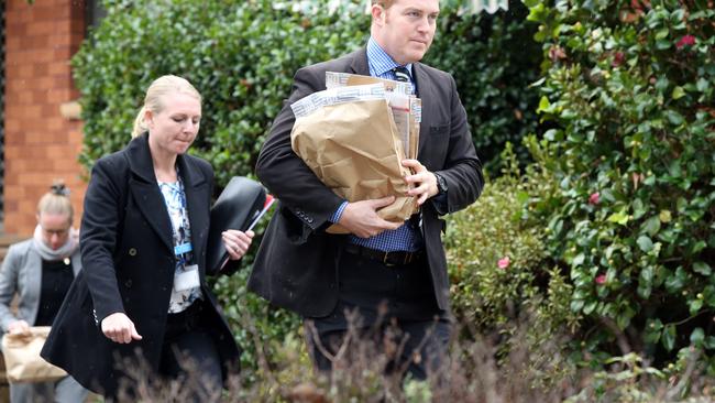 Detectives remove evidence from the Carlingford home. Picture: Richard Dobson