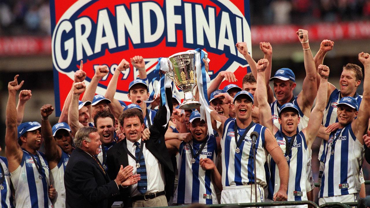 Pagan and the North Melbourne players after winning the AFL Grand Final in 1999.