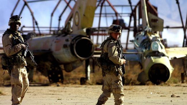 United States Army soldiers patrol an airfield littered with Soviet MiG fighters abandoned at the end of the Soviet-Afghan conflict, within Bagram Airbase. Picture: AP.