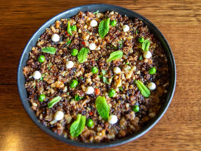 Malik’s extremely more-ish, sauteed cauliflower is served on a bed of muhammara, a roasted red capsicum sauce and topped with mint and yoghurt. Picture: Linda Higginson