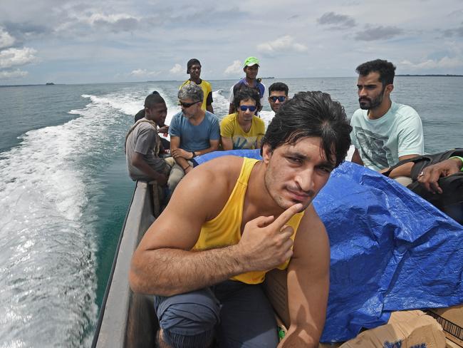 Asylum seekers take urgently needed foods and medicines back to the Lombrum detention centre by boat. Picture: Brian Cassey