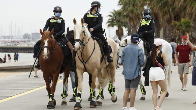 Police patrol St Kilda beach after revellers illegally gathered. Picture: Daniel Pockett