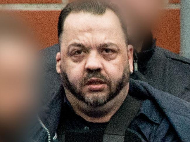 Former nurse Niels Hoegel, accused of killing more than 100 patients in his care, wears a bullet proof vest as he is lead out of the court compound towards a prisoner's transport vehicle, on October 2018 in Oldenburg, northern Germany, after the first day of his trial. - Hoegel, 41, has already spent nearly a decade in prison for other patient deaths, and is accused of intentionally administering medical overdoses to victims so he could bring them back to life at the last moment. (Photo by Hauke-Christian Dittrich / DPA / AFP) / Germany OUT