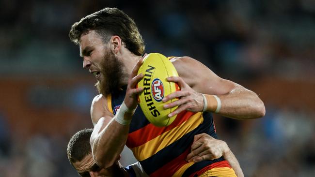 ADELAIDE, AUSTRALIA - AUGUST 11:   Riley Thilthorpe of the Crows  tackled by   Liam Jones of the Bulldogs during the round 22 AFL match between Adelaide Crows and Western Bulldogs at Adelaide Oval, on August 11, 2024, in Adelaide, Australia. (Photo by Mark Brake/Getty Images)