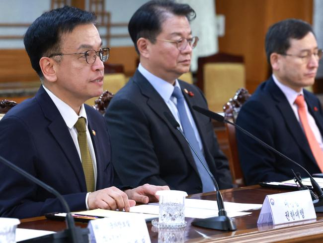 South Korea's Finance Minister and new acting president Choi Sang-mok (left) speaks as he presides over a meeting of the National Security Council at the Government Complex in Seoul, after Prime Minister Han Duck-soo's impeachment motion was passed by the National Assembly. Picture: Yonhap/AFP