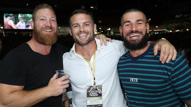 Former NRL players Michael Crocker (left) and Daniel Conn (centre) with Titans star Nathan Peats at the fight. Picture: Annette Dew