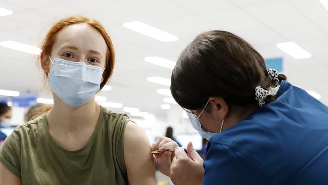 Nurse Zoe Robinson giving Amy Yarrow, 18, her second COVID-19 vaccination at the Sydney Olympic Park NSW Health vaccination centre. Picture: Jonathan Ng