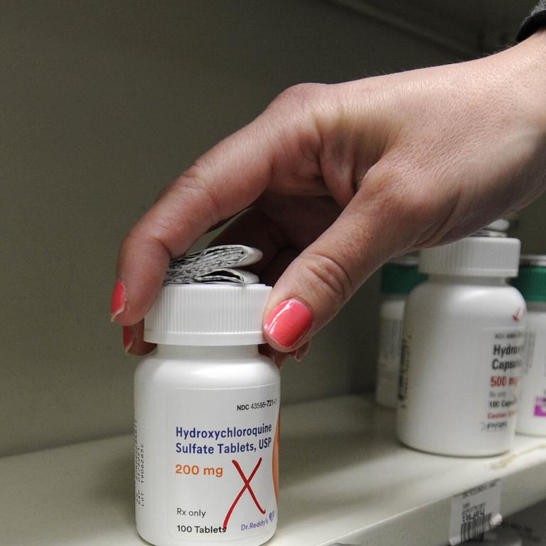 A pharmacist reaches for a bottle of hydroxychloroquine. Australia will soon start receiving the drug. Picture: Mark Moran / The Citizens' Voice via AP