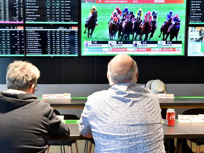 Customer's are seen inside a Tabcorp venue in Brisbane, Wednesday, August 14, 2019. Tabcorp Holdings, which operates in the gambling and media industry announced a net profit after tax (NPAT) result for the full year of $362.5 million and revenue of $5.5 billion from its Lottery, Keno, TAB, and Sky Racing business. (AAP Image/Darren England) NO ARCHIVING