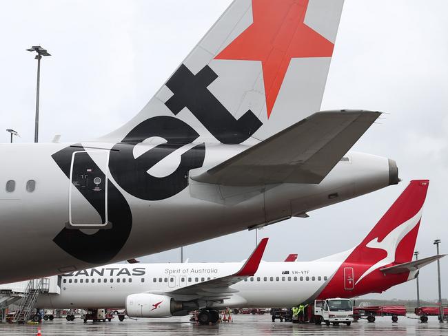 A Jetstar Airbus A320 and Qantas Boeing 737-800  jet aircraft at Cairns Airport after touchdown, bringing tourists and tourism dollars to Far North Queensland. Picture: Brendan Radkeescape december 6 2020 doc holiday