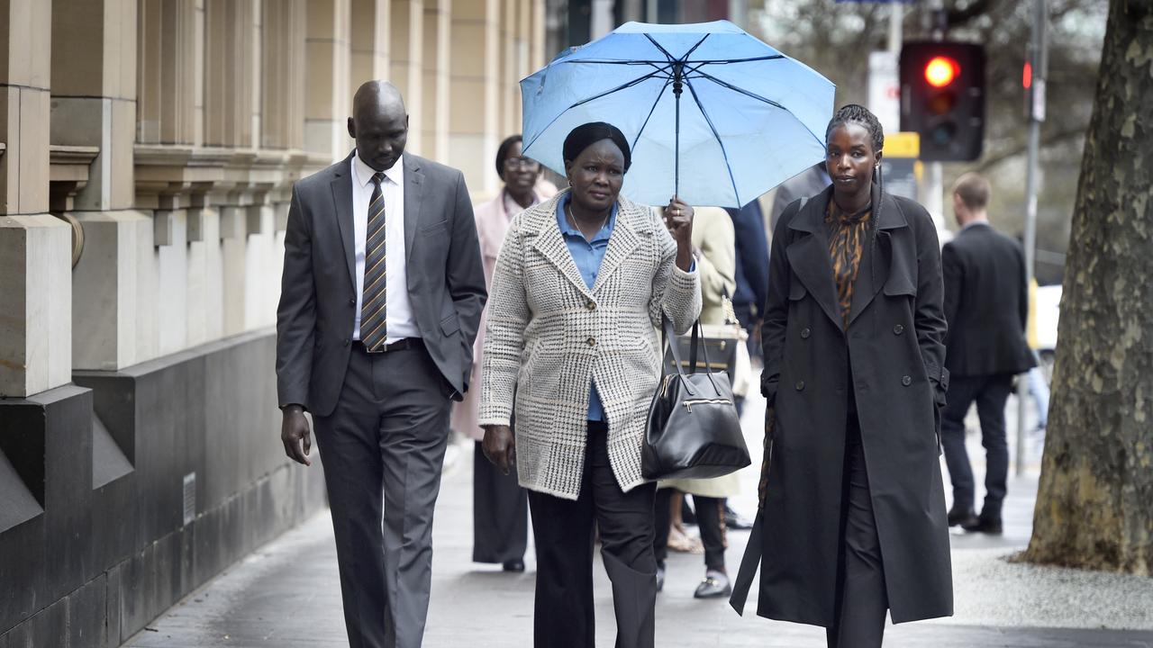 Elizabeth Malek and Kuol Riak, mother (centre) and brother (left) of WA basketball player Alier Riak . Picture: NewsWire / Andrew Henshaw