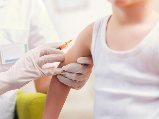 Pediatrician makes vaccination to small boy