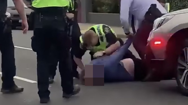 Images from Facebook of a man wielding a knife being arrested by Tasmania Police in Montrose.