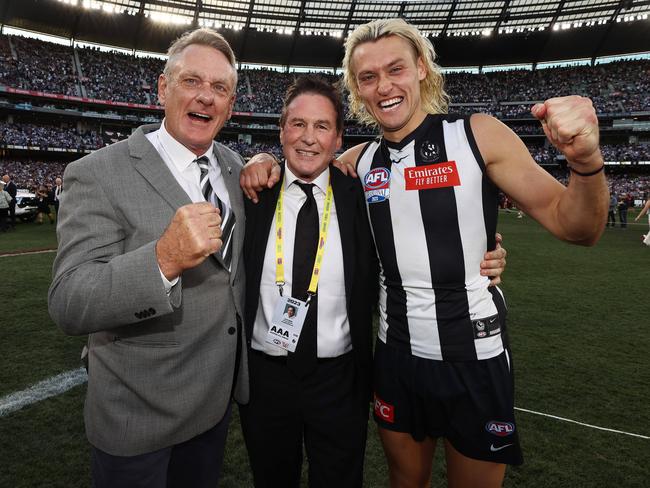 Jeff Browne with Darcy and Peter Moore after Collingwood’s grand final victory. Picture: Michael Klein