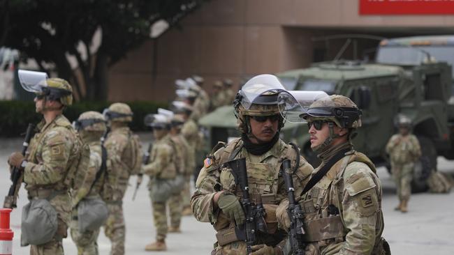 U.S. National Guard are deployed outside the federal prison in downtown Los Angeles, Sunday, June 8, 2025, following a immigration raid protest the night before. (AP Photo/Jae Hong)