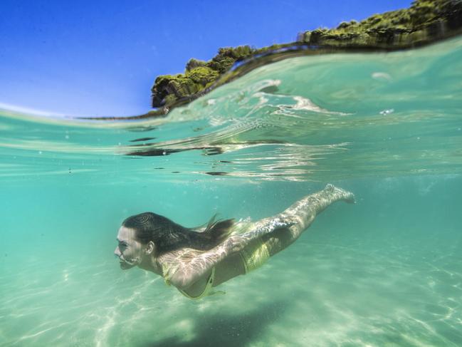 Tallebudgera Creek usually offers crystal clear waters and calm conditions for swimming. Ashleigh Allerton from Brisbane takes a dip at Talle. Picture: NIGEL HALLETT 