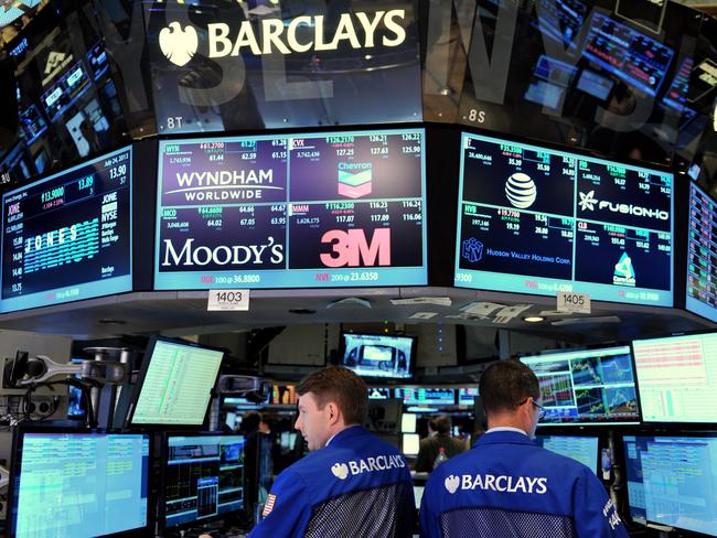 (FILES) In this July 24, 2013 file phot, specialists work at the Barclays post on the floor of the New York Stock Exchange just after the closing bell in New York. New York's financial regulator announced NOvember 18, 2015 another $150 million fine against British bank Barclays over its 