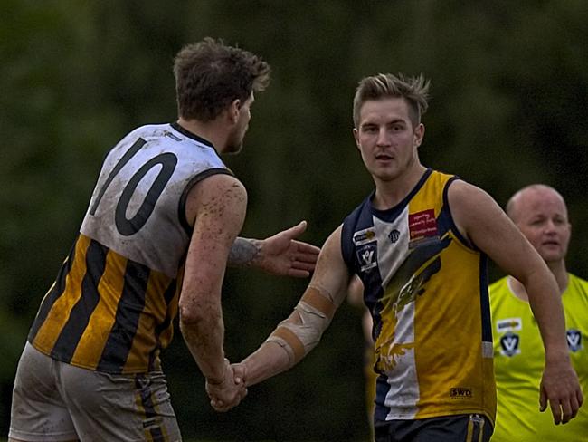 Beaconsfield and Upwey Tecoma players shake hands after the final siren